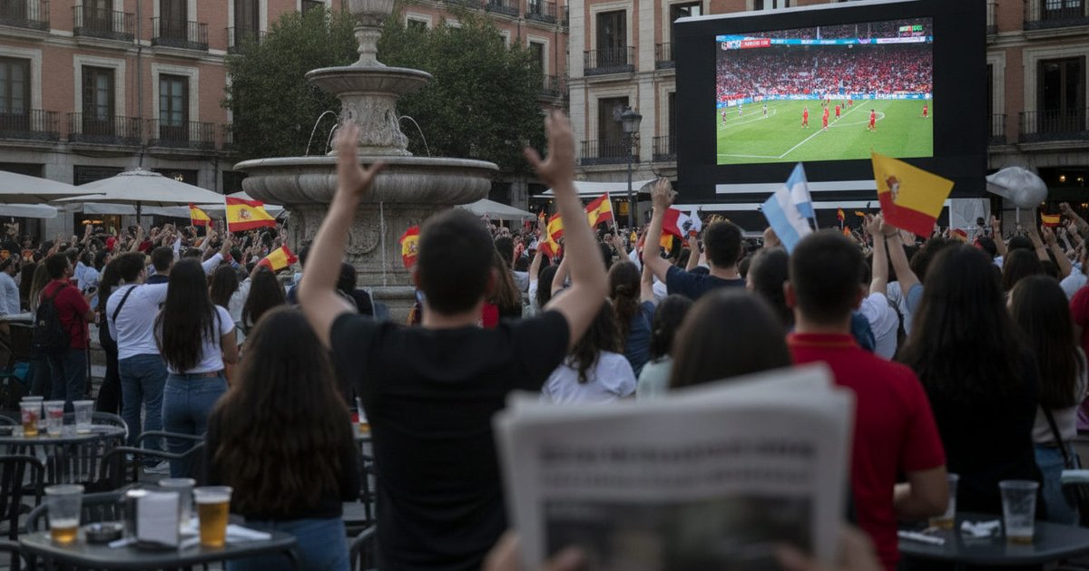 Aficionados de diversas nacionalidades siguiendo con entusiasmo un partido del Mundial 2026 en una pantalla gigante en un espacio público de España.